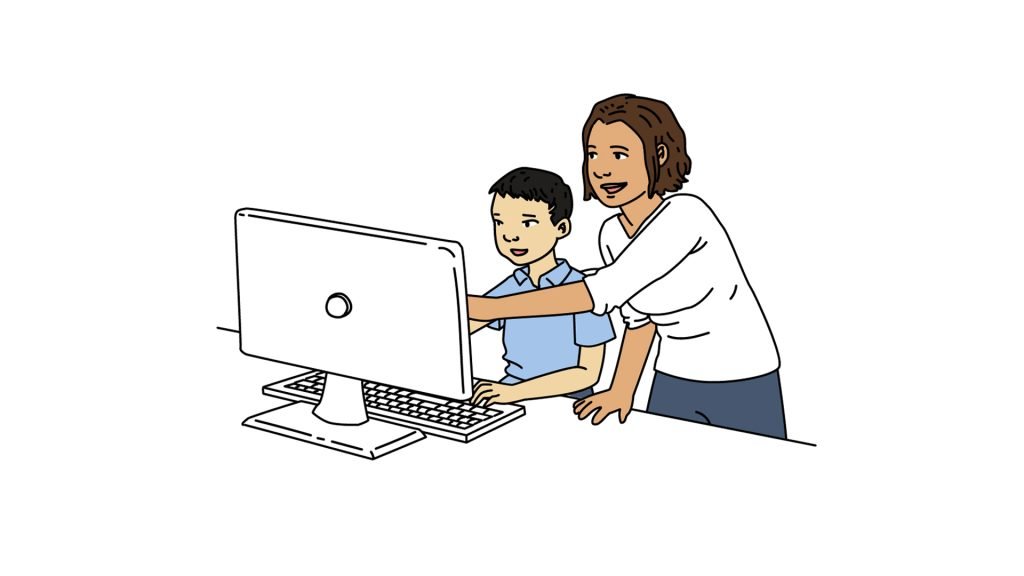 Teacher helping a student at the computer